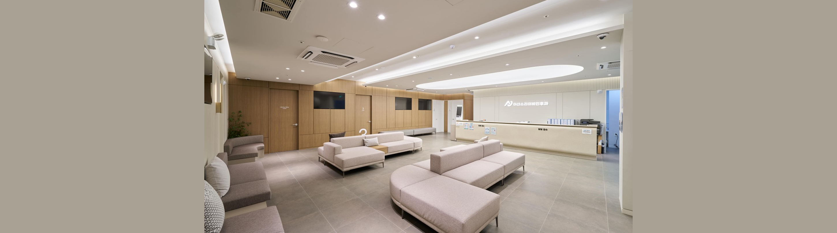 Spacious lobby interior of Asan Soree ENT Clinic with modern sofas and reception desk